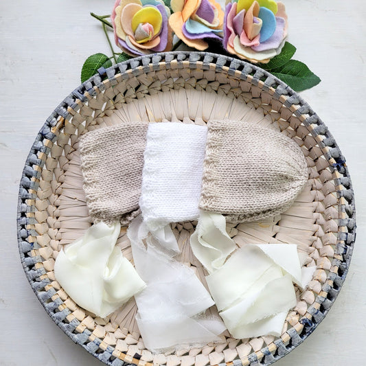 newborn baby girl bonnet in white or beige with ribbons for a photo shoot