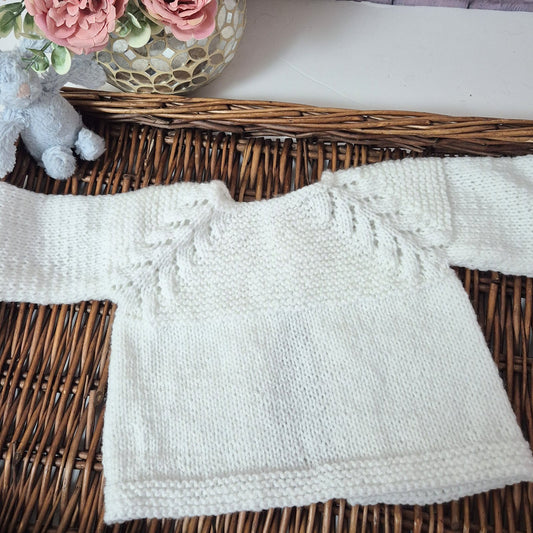 white knitted baby jumper