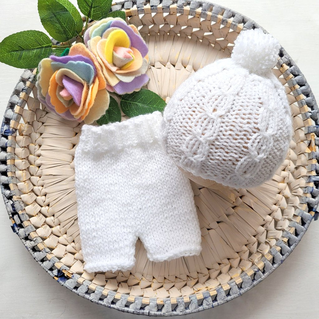 white knitted baby boy outfit comprising shorts and beanie