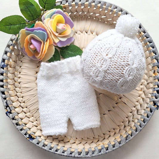 white knitted baby boy outfit comprising shorts and beanie