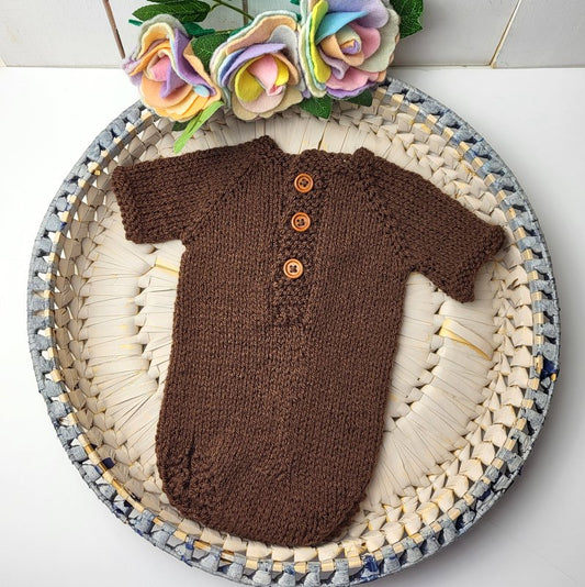 KNIT BROWN SHORT SLEEVED NEWBORN ROMPER WITH THREE WOODEN BUTTONS DOWN THE FRONT