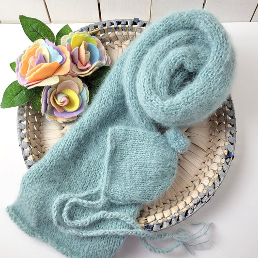 thick fluffy long knit wrap and pom bonnet for a newborn baby boy first photo shoot