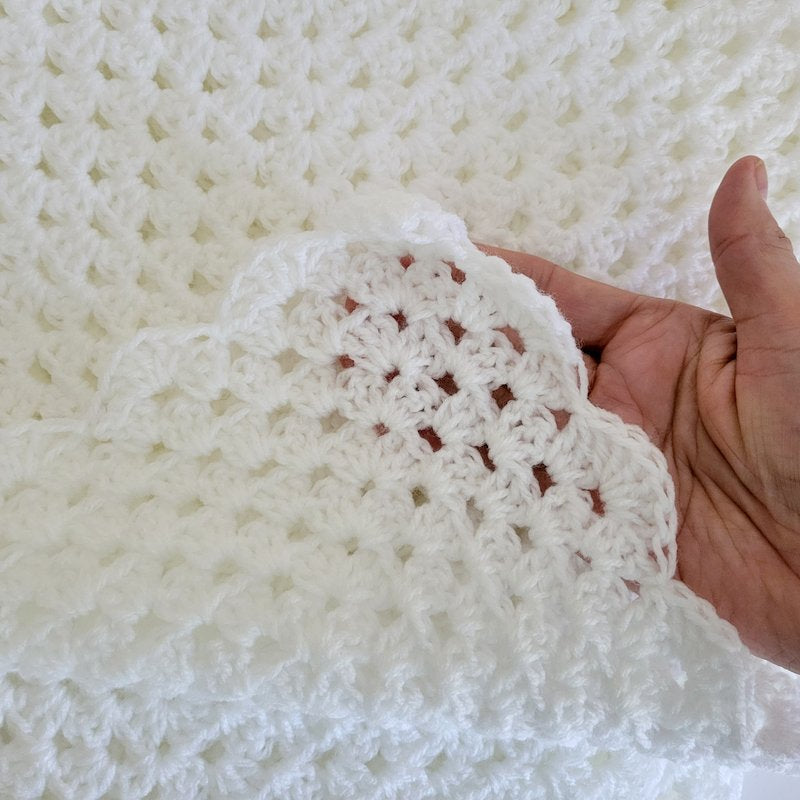 closeup of white crochet baby blanket