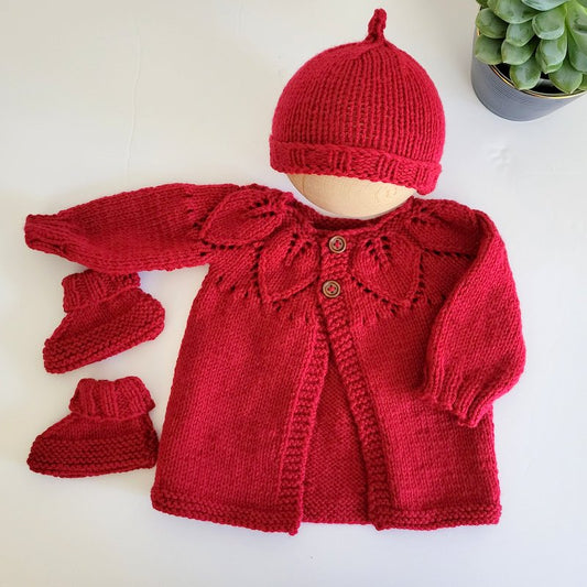 red knitted baby jumper with hat and booties for babys first Christmas