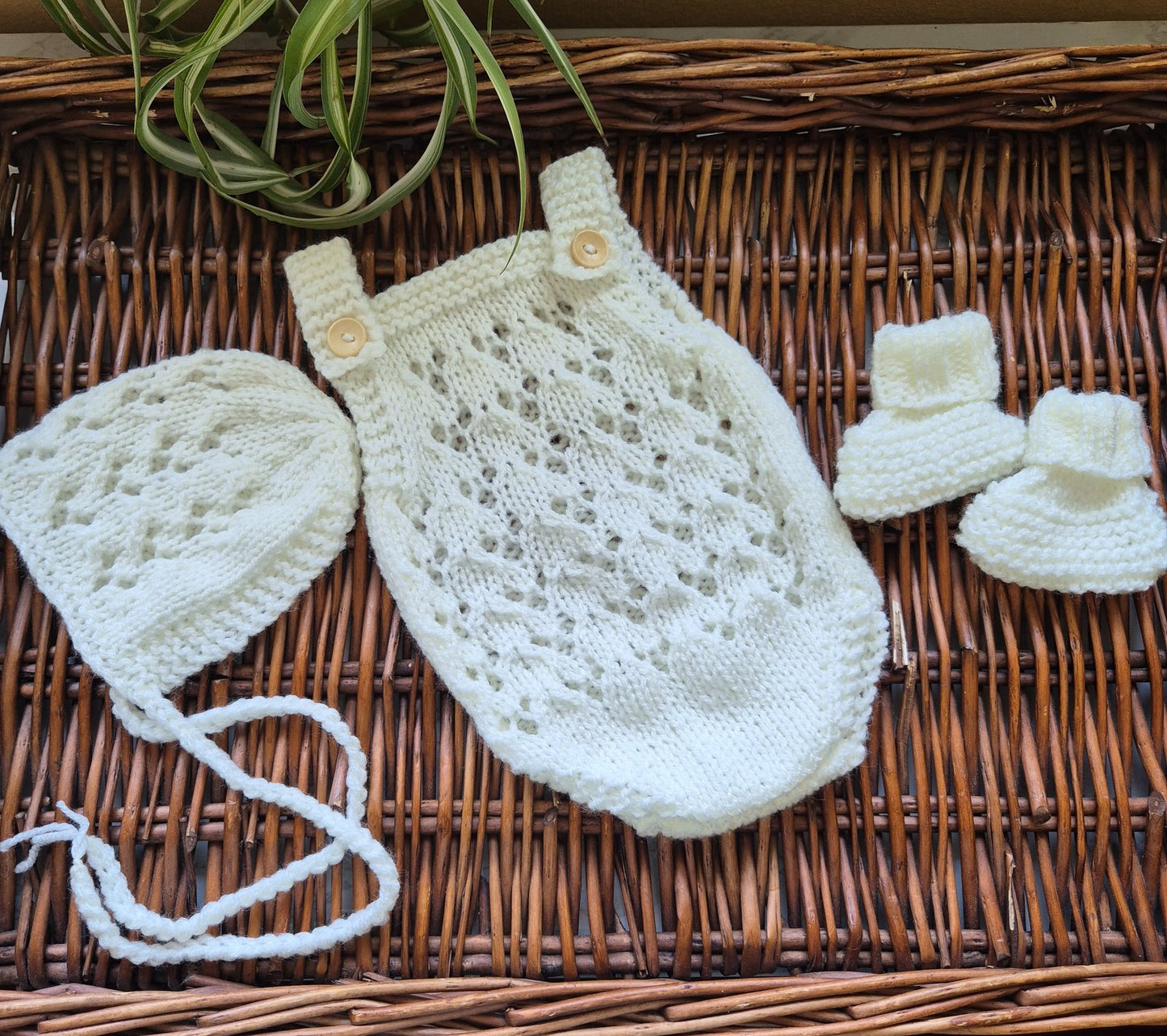A knitted baby romper with an all-over lace pattern and shoulder straps, and an optional matching bonnet. Made in sizes newborn prop to 3 months old. The romper has a button on each shoulder strap. Perfect as a hospital coming home outfit, newborn photography prop or baby shower present. All my knitwear is shipped in an organza bag, ready for you to gift.
 
Handmade in soft acrylic yarn that can be washed on a delicate cycle. Choose from white, cream, green, beige or pinks.