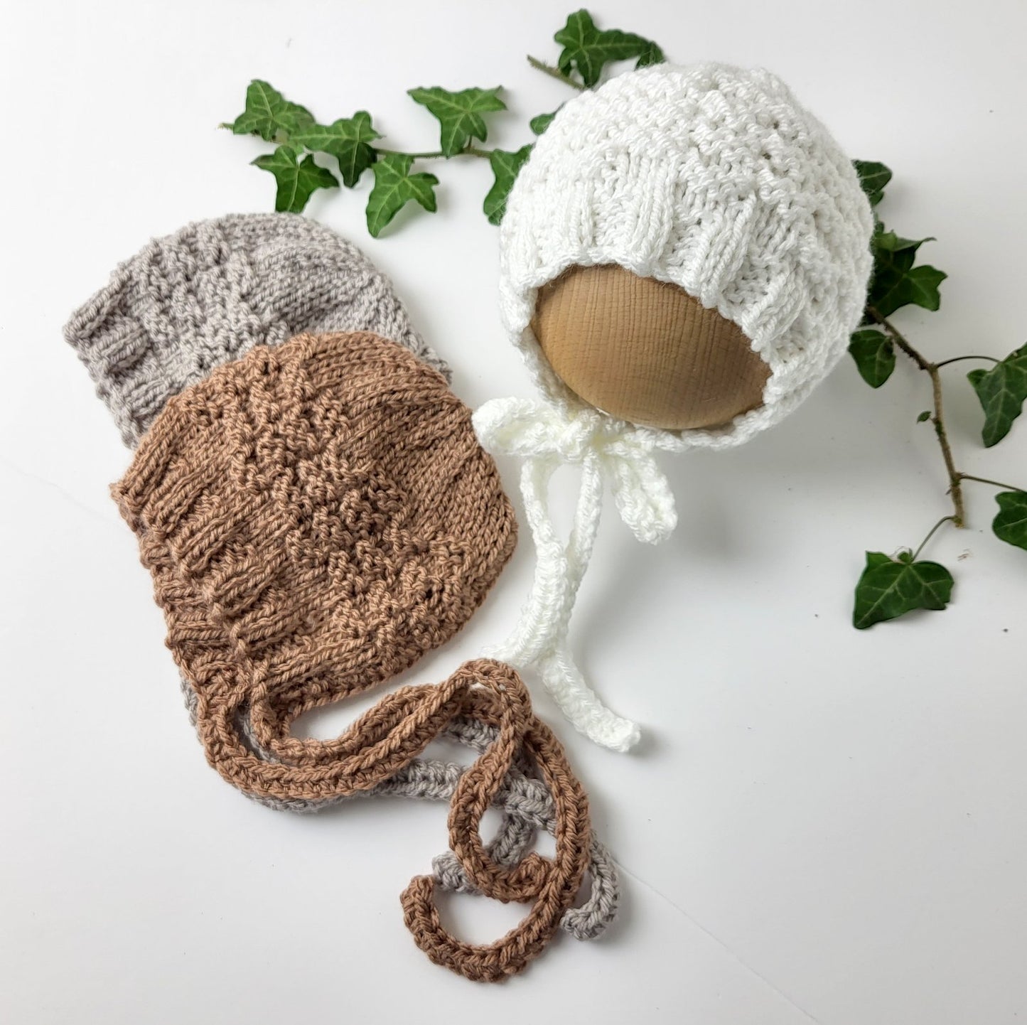 hand made knitted baby bonnet with a textured pattern , choose from white or brown or beige