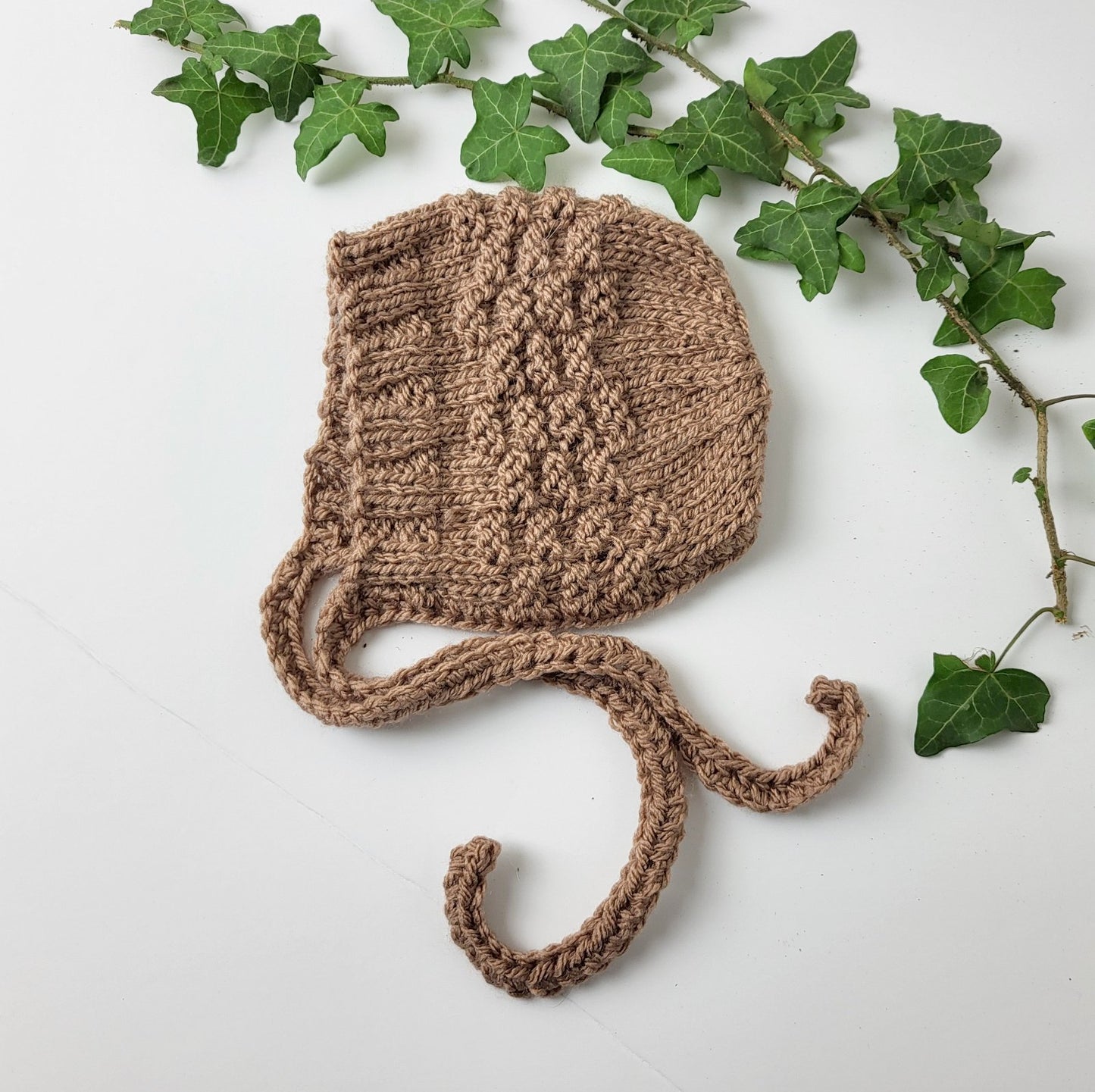 handknit baby bonnet in brown