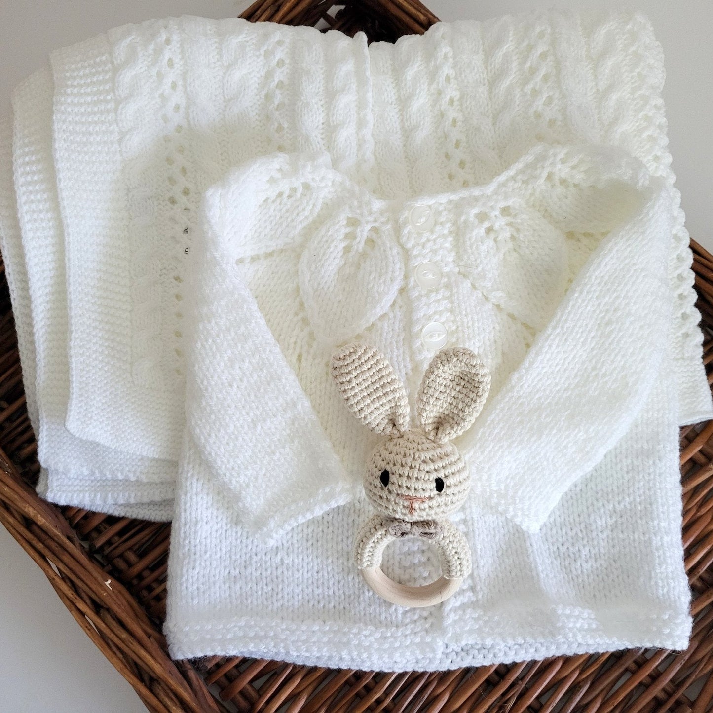 Handmade baby gift set comprising and handknit baby cardigan and a baby blanket with a little bunny rabbit rattle