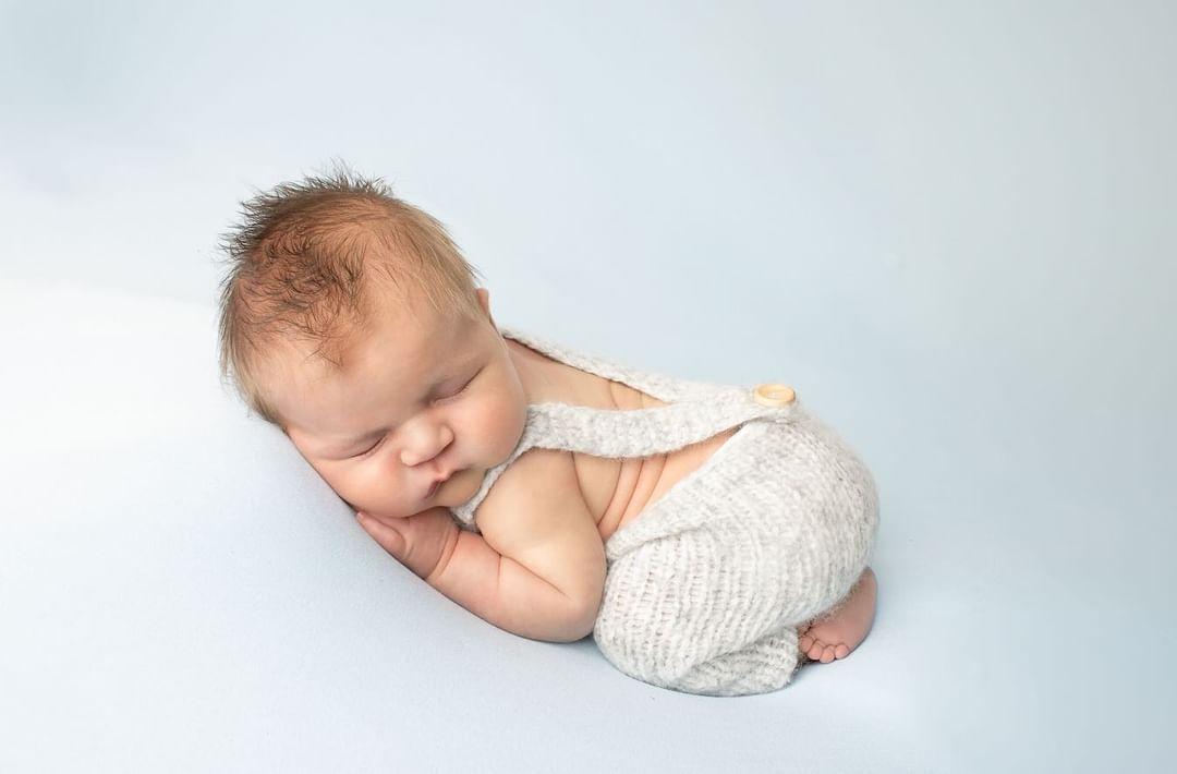 knitted baby dungarees overalls for a newborn photo shoot or baby shower gift