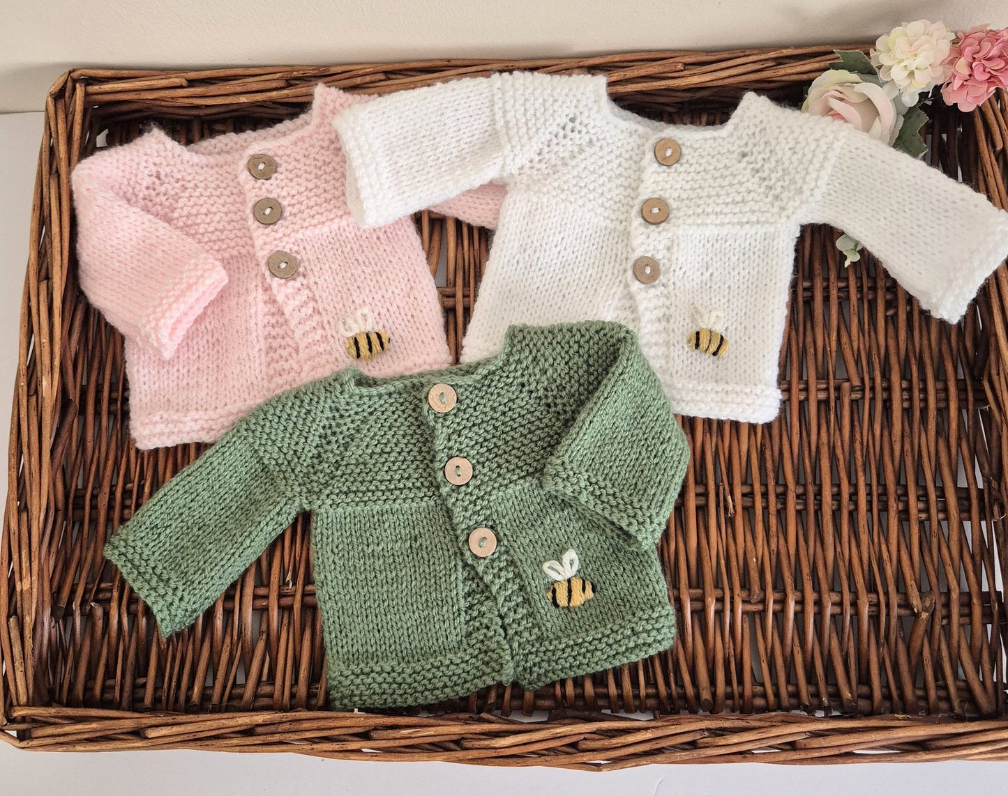 Knitted Preemie to Newborn size Baby Cardigan with wooden buttons and a small embroidered bee motif on the front. Ready to send.

Knit in soft acrylic yarn, that is easy to wash, with coconut shell buttons. A simple, classic style cardigan with a ridged pattern on the bodice. Ideal as a gift for a tiny baby, as a hospital coming home outfit for a newborn or baby shower present. Each cardigan is shipped in an organza bag, ready for you to gift.