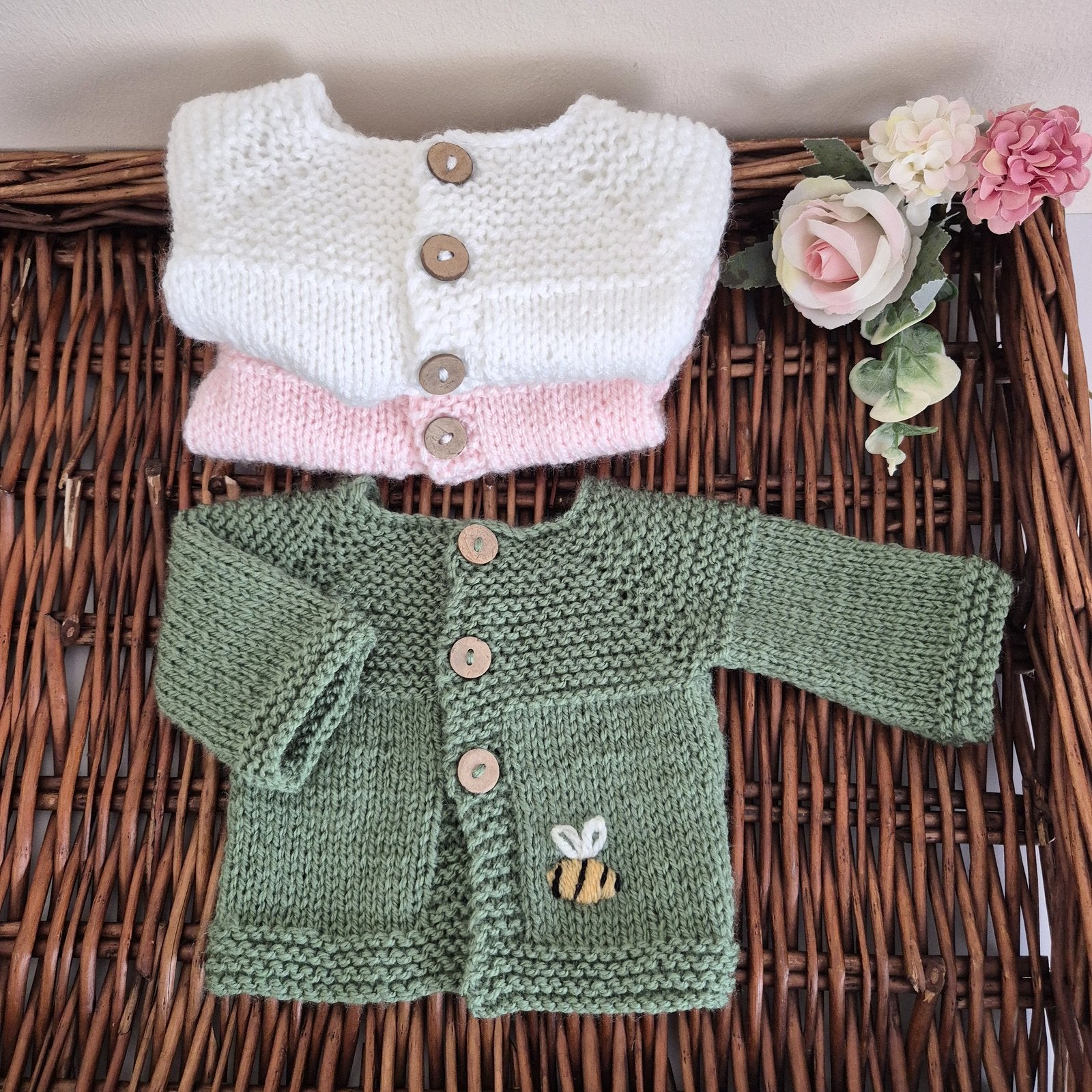 Knitted Preemie to Newborn size Baby Cardigan with wooden buttons and a small embroidered bee motif on the front. Ready to send.

Knit in soft acrylic yarn, that is easy to wash, with coconut shell buttons. A simple, classic style cardigan with a ridged pattern on the bodice. Ideal as a gift for a tiny baby, as a hospital coming home outfit for a newborn or baby shower present. Each cardigan is shipped in an organza bag, ready for you to gift.