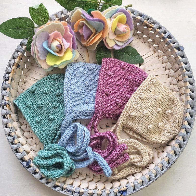handknit newborn baby bonnets with a popcorn pattern 