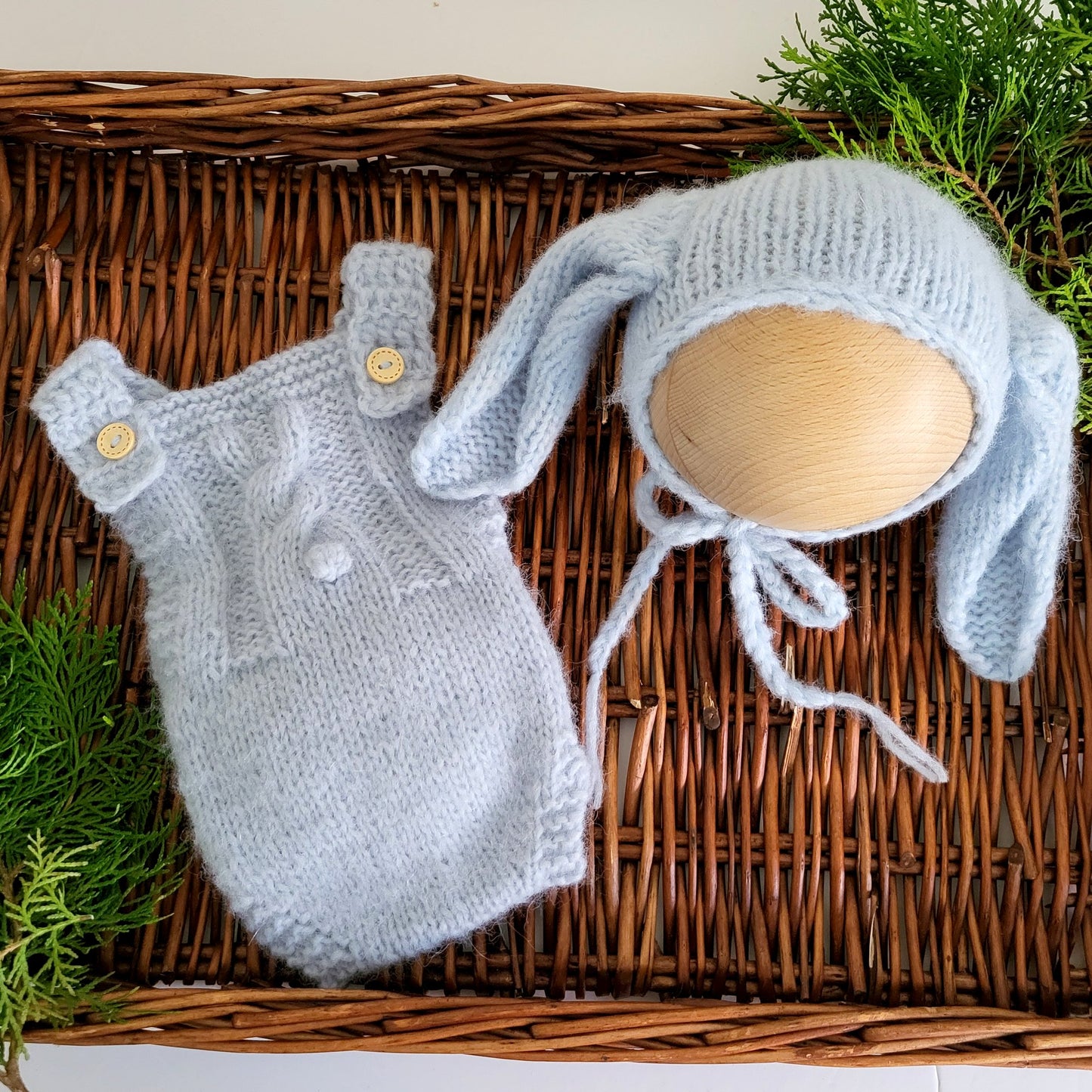 handmade knitted baby romper in light blue, with bunny motif and bunny ears bonnet
