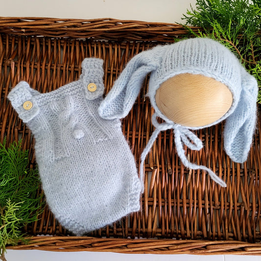 handmade knitted baby romper in light blue, with bunny motif and bunny ears bonnet
