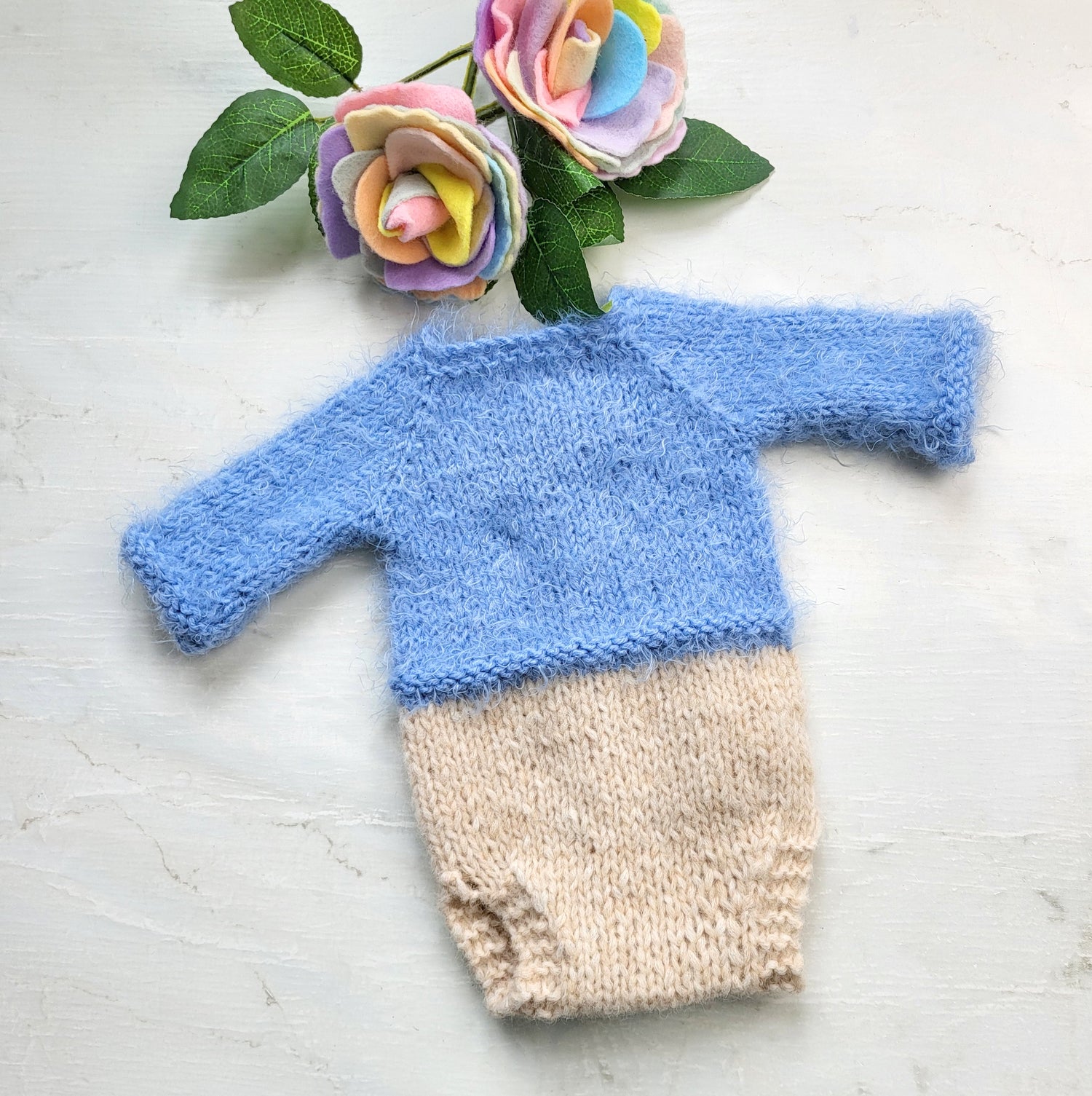 knitted newborn romper with long sleeves props