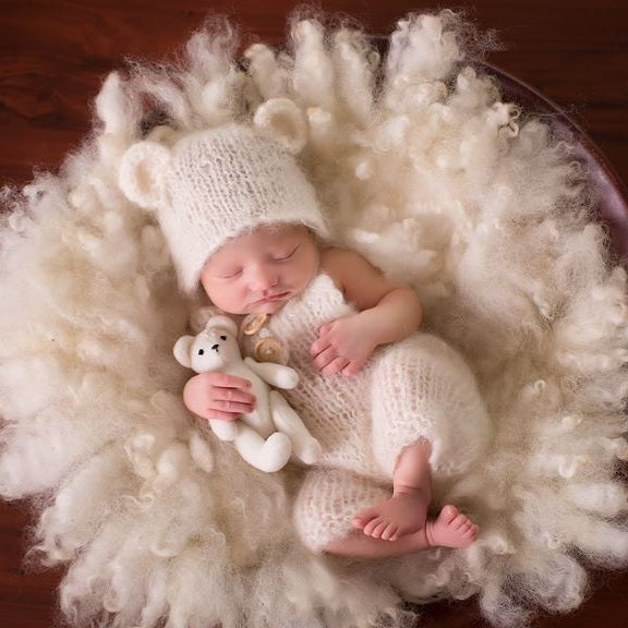 White knitted baby dungaree coveralls and bear bonnet