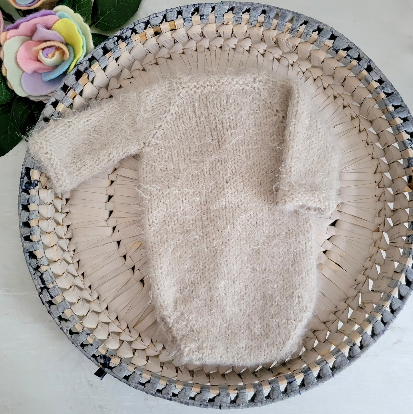 knitted newborn romper in fluffy beige