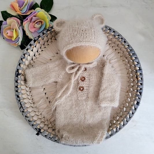beige knitted newborn romper with long sleeves and buttons down the front with matching bear bonnet newborn photo prop