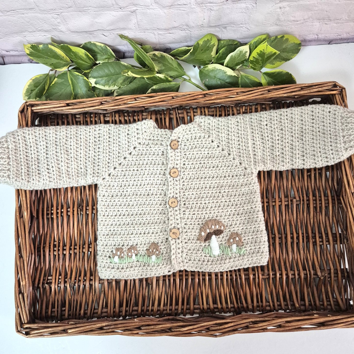 A gorgeous handmade crochet baby cardigan to fit a baby of 0-6 months This little jumper has coconut shell buttons and little toadstools embroidered on the front. 