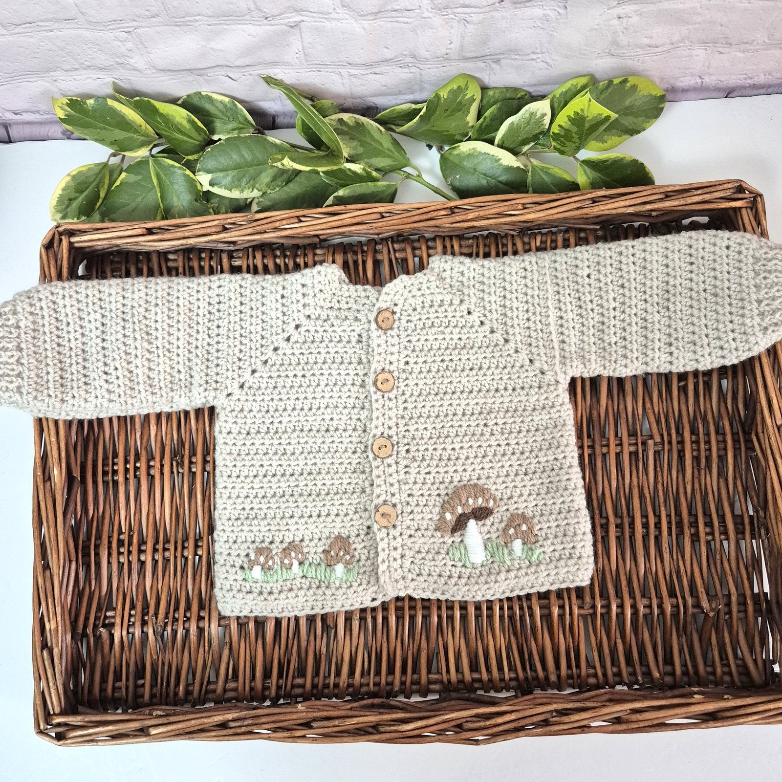 A gorgeous handmade crochet baby cardigan to fit a baby of 0-6 months This little jumper has coconut shell buttons and little toadstools embroidered on the front. 