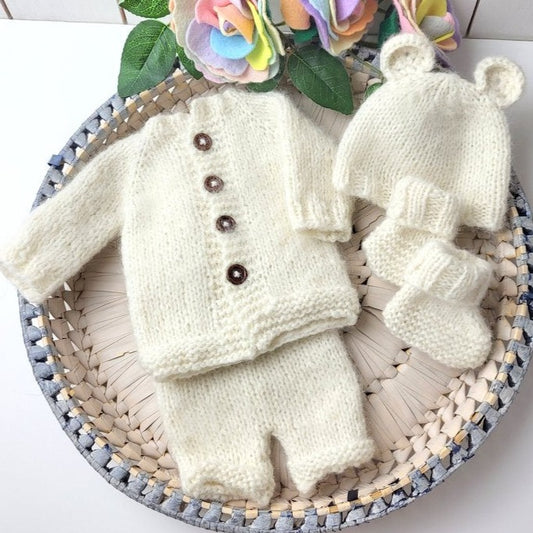 handknit baby coming home outfit for a newborn photo shoot, cream knit jumper , knit baby shorts, booties and matching bear beanie