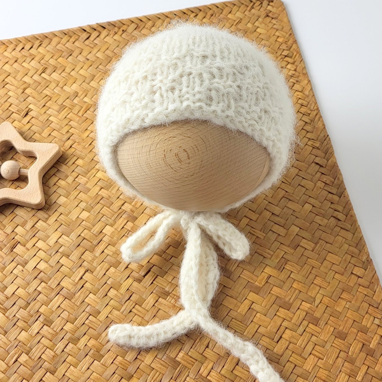 knitted cream bonnet for a newborn baby