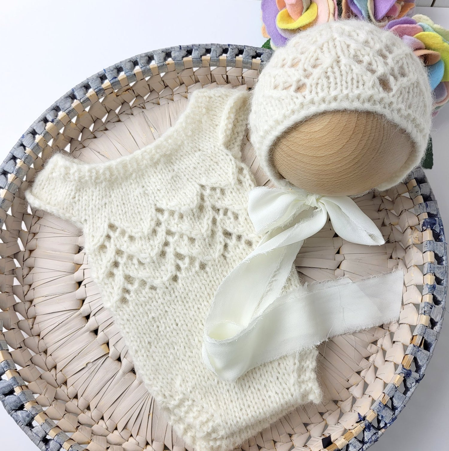 cream knitted lacy romper and bonnet for newborn photo shoots