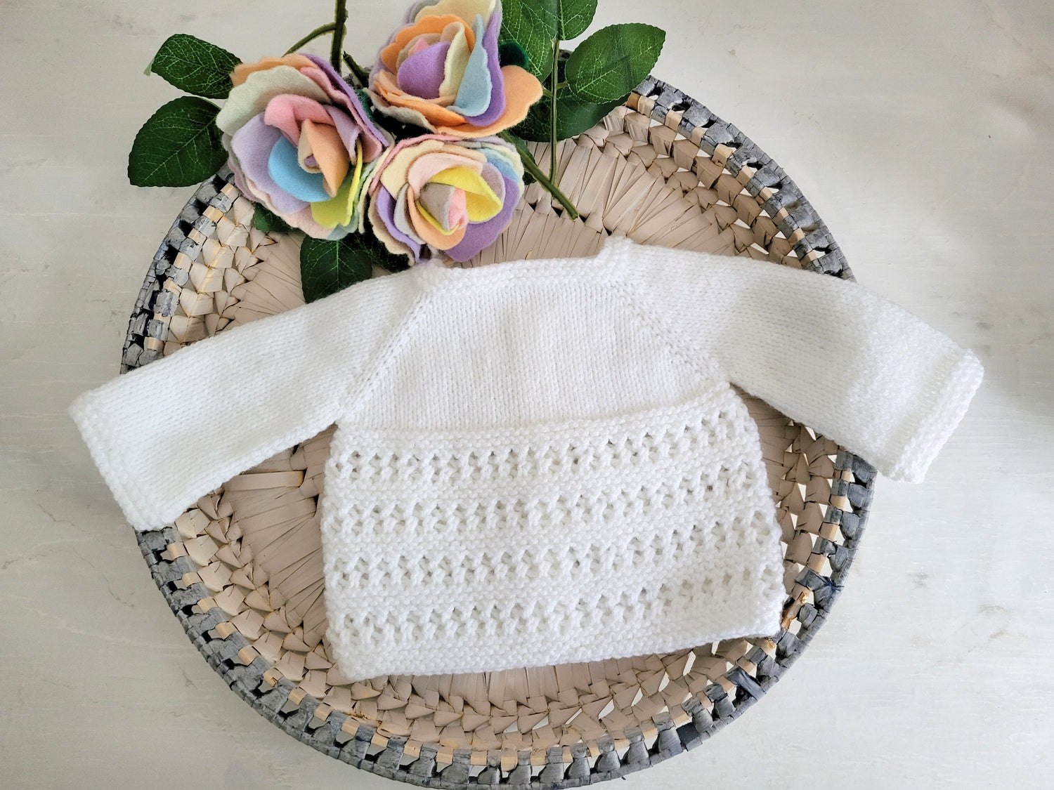 back view of a knit white jumper for babies
