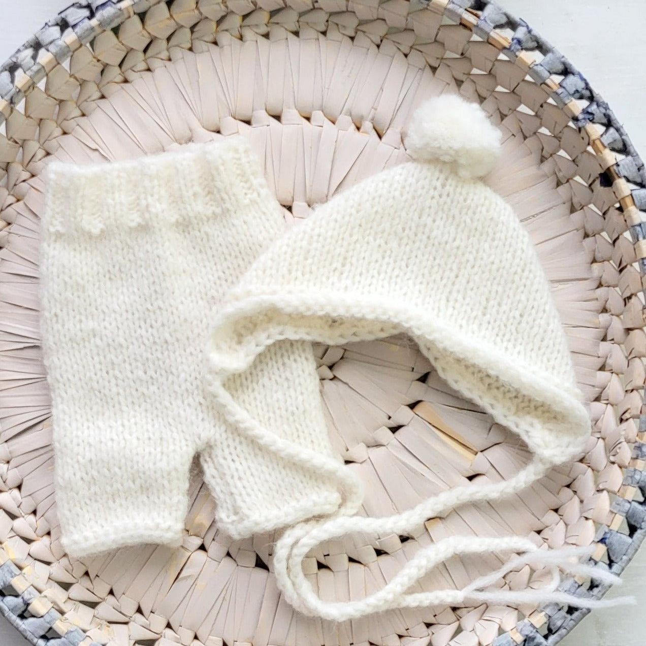 handknit cream newborn shorts and pom pom bonnet for photography prop use