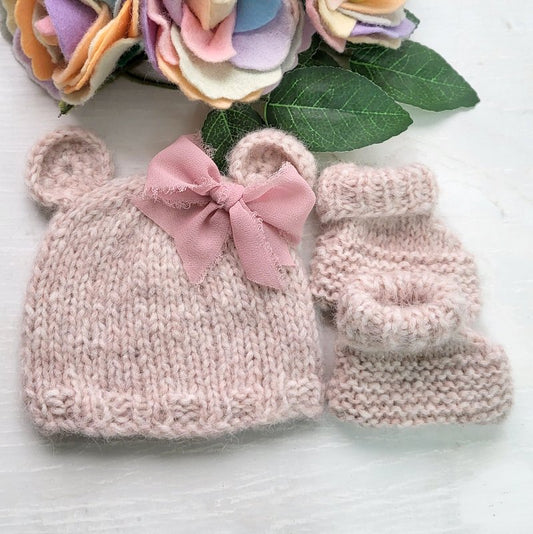 pink knitted baby bear hat with bow and matching bootie socks