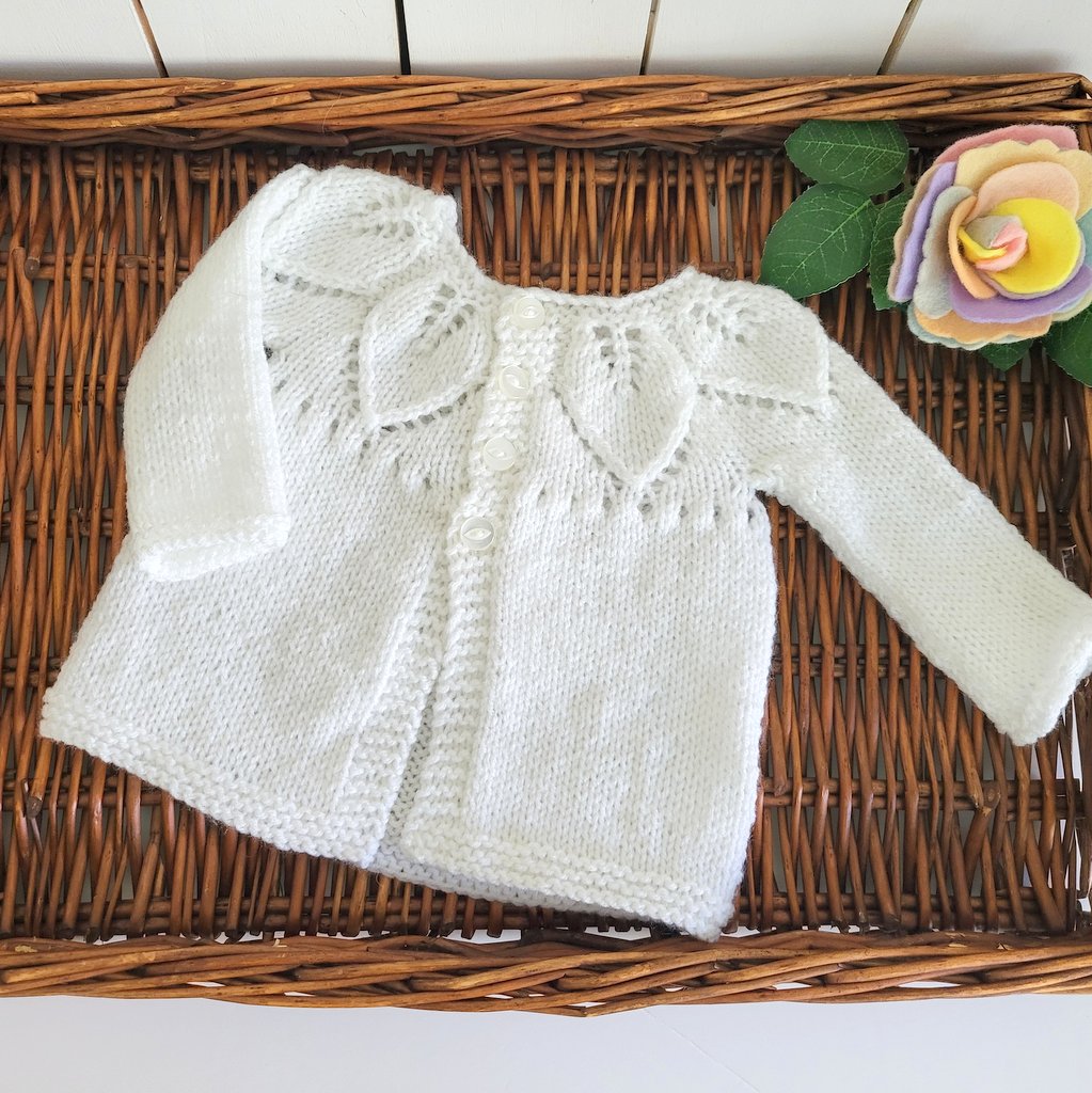 handknit baby jumper cardigan in white with leaf pattern