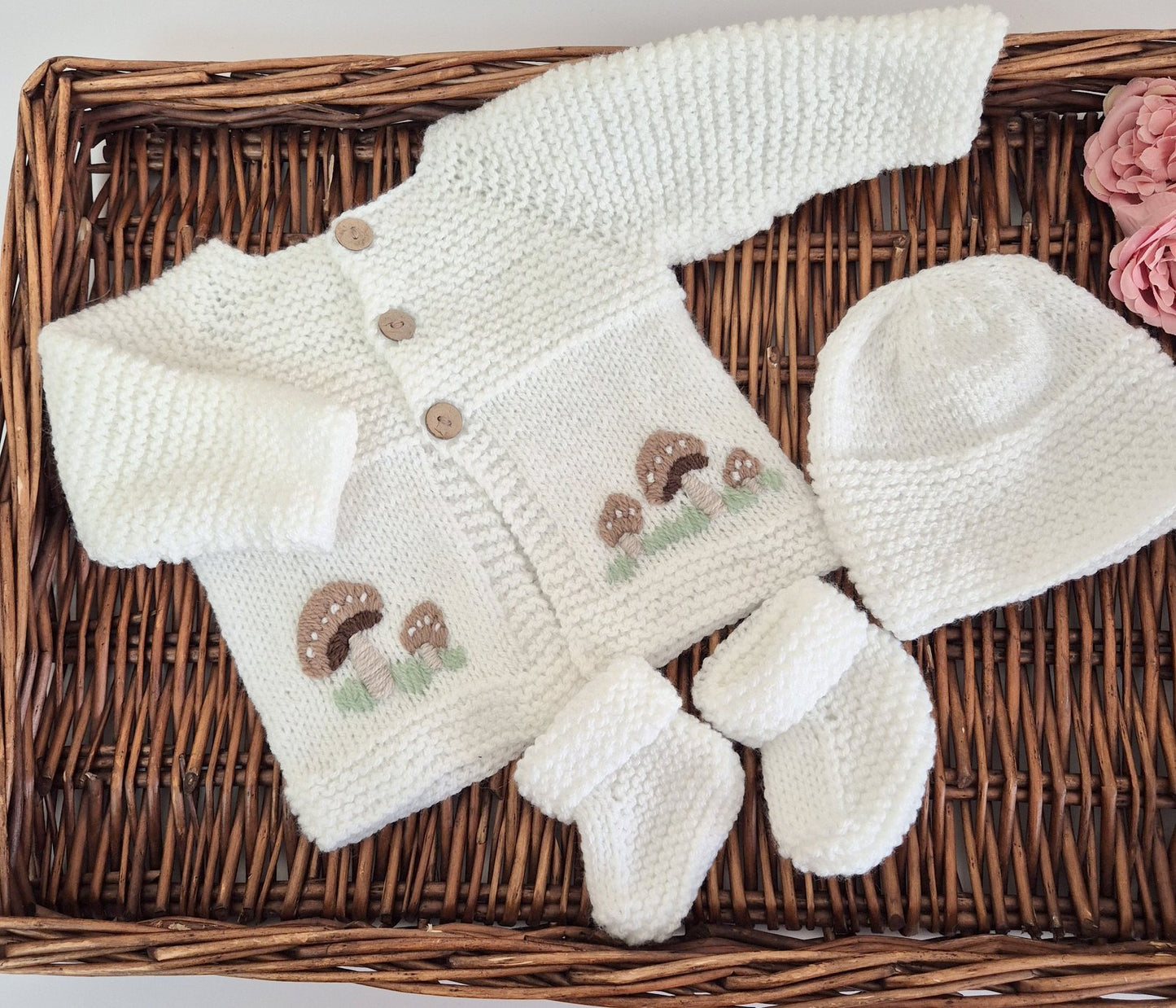 White hand knit baby cardigan, hat and booties set. Embroidered with little brown button mushrooms. Jumper, 0-6 months Sweater.

This cardigan has a raised pattern on the chest, with coconut shell buttons, and toadstool embroidery on the front. A matching white hat and booties complete the set.

Knit in soft acrylic yarn, easy for a busy mum to wash.