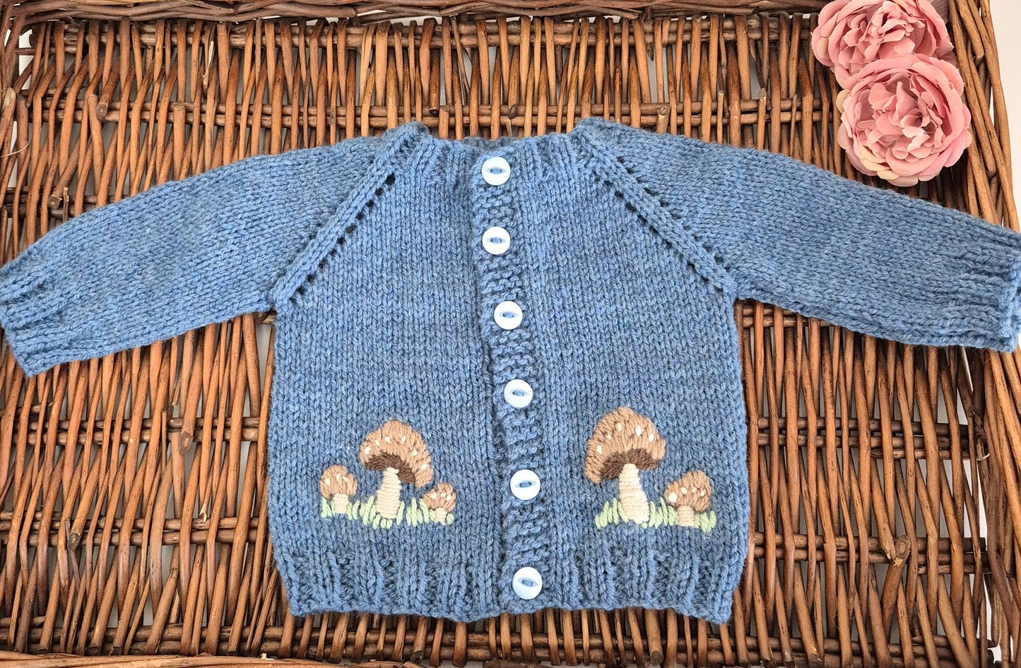 Knitted Dark Blue cardigan and hat set for a baby boy. The set comprises a gorgeous hand knit baby cardigan with brown embroidered toadstool mushrooms on the front. A matching beanie completes the set.
Designed to fit a 0-3 month old baby. The cardigan has blue buttons down the front.

A timeless classic style jumper gift set that will fit in any wardrobe.
Perfect as a gift for a new baby, at a baby shower for baby boys. This would be lovely for a woodland themed party or nursery.

The set is shipped in a w