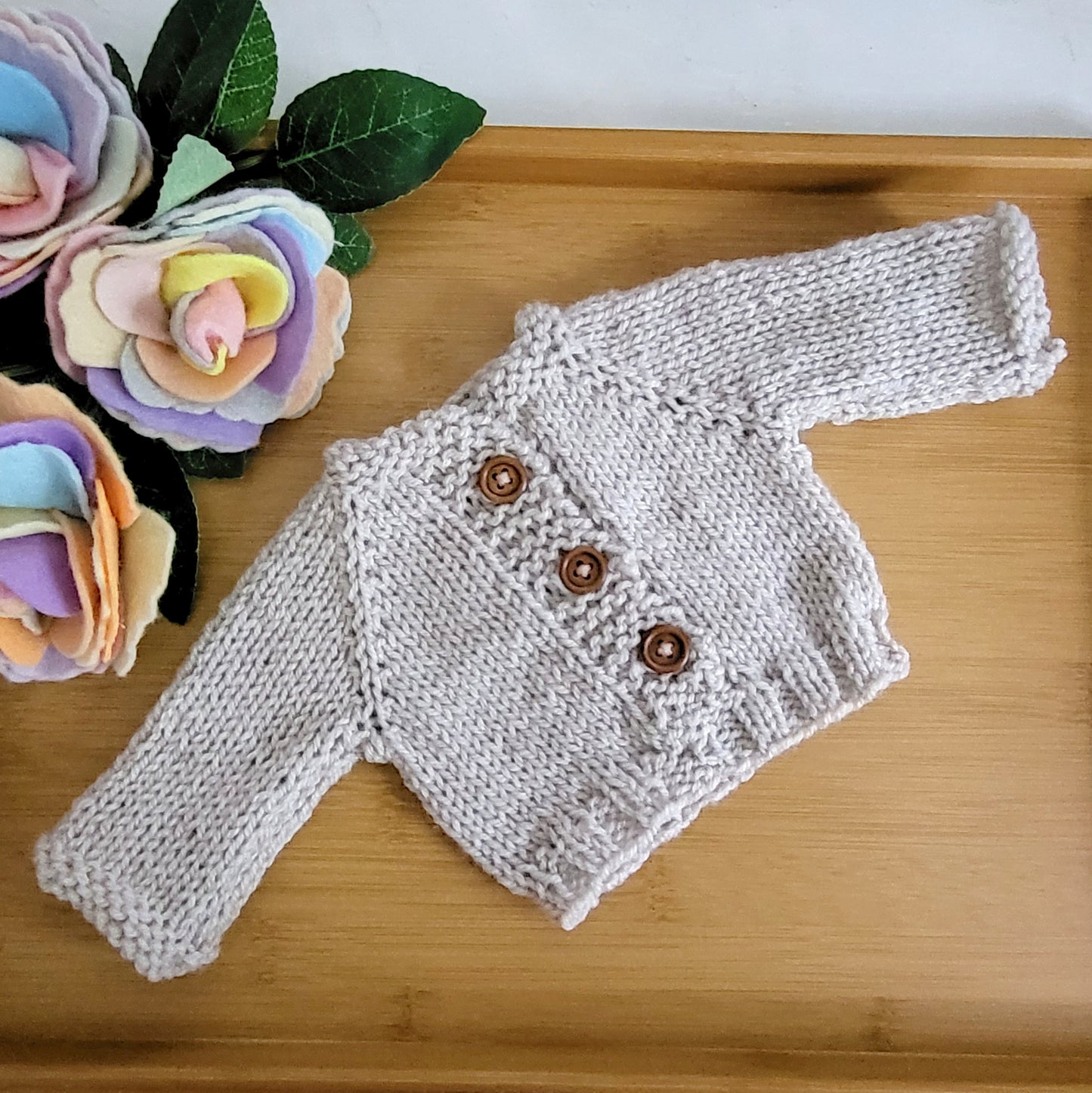 knitted beige newborn cardigan with wooden buttons