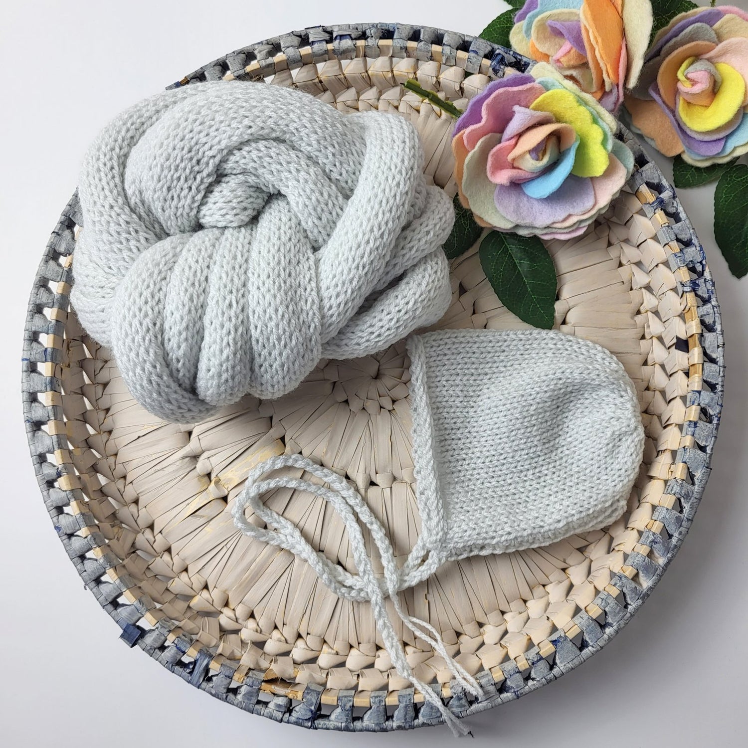pale grey knitted newborn bonnet and swaddle wrap set