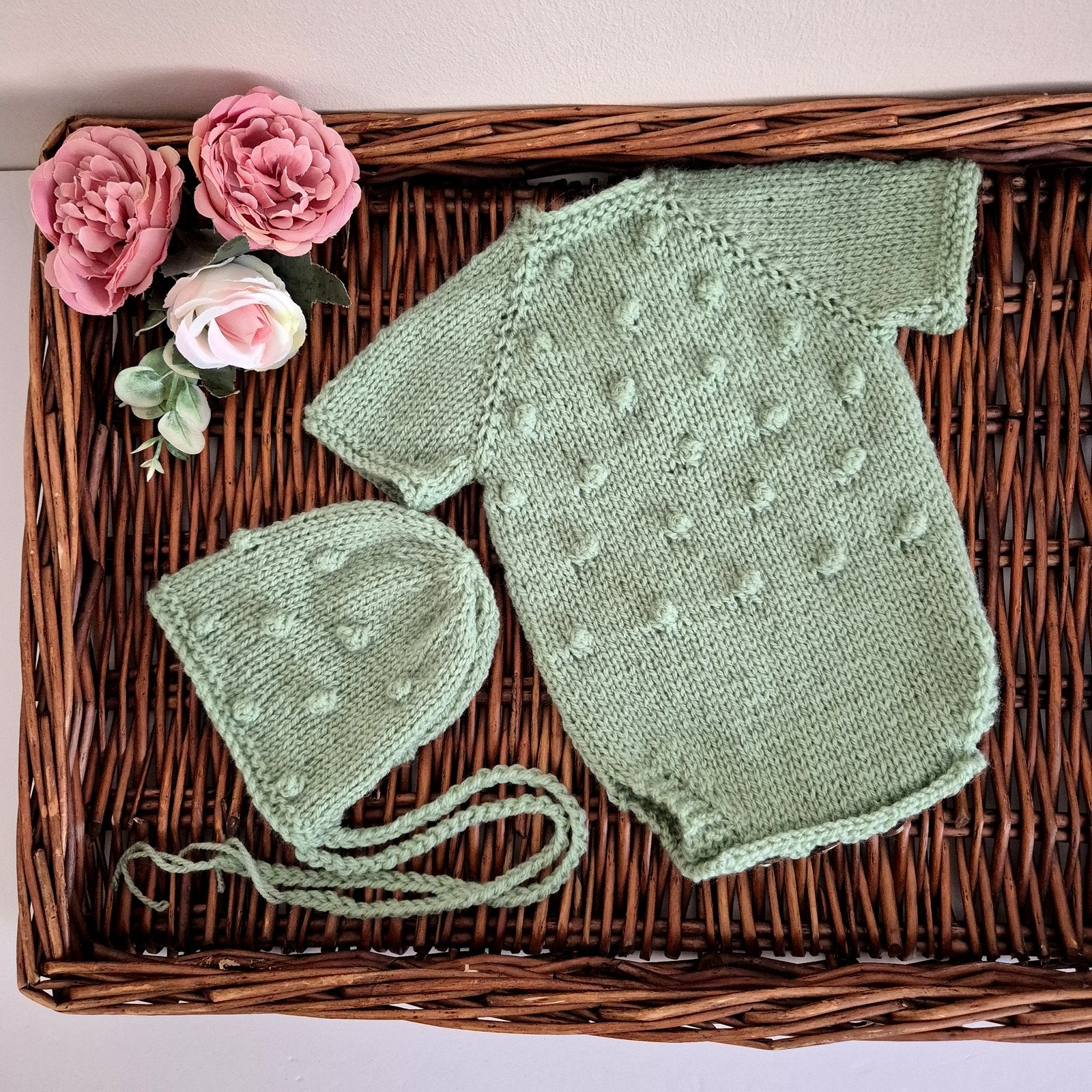 Handmade knitted sage green newborn baby romper and bonnet set. Ready to send.

The bodysuit-style romper outfit has all-over popcorn bubble texture, with short sleeves. It has wooden button fastenings at the back neck and diaper opening, designed for newborns under 20 days old. Perfect as a hospital coming home outfit, newborn photography prop, or baby shower gift.

Knitted using my own original designs, shipped ready to gift&nbsp; in an organza bag. Dispatched from the UK.

Ideal for first photos and spec