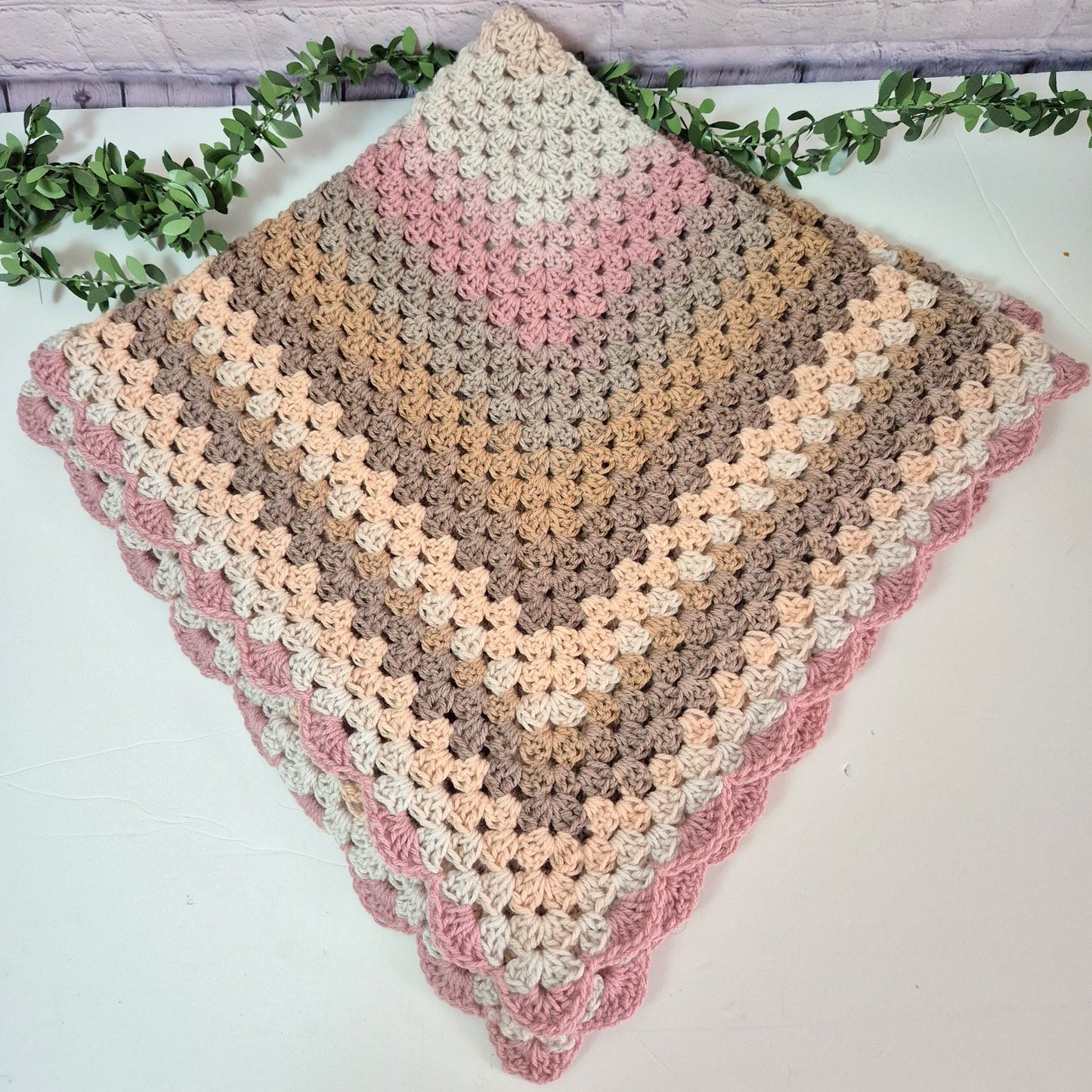 crochet pink cream and brown baby blanket 
