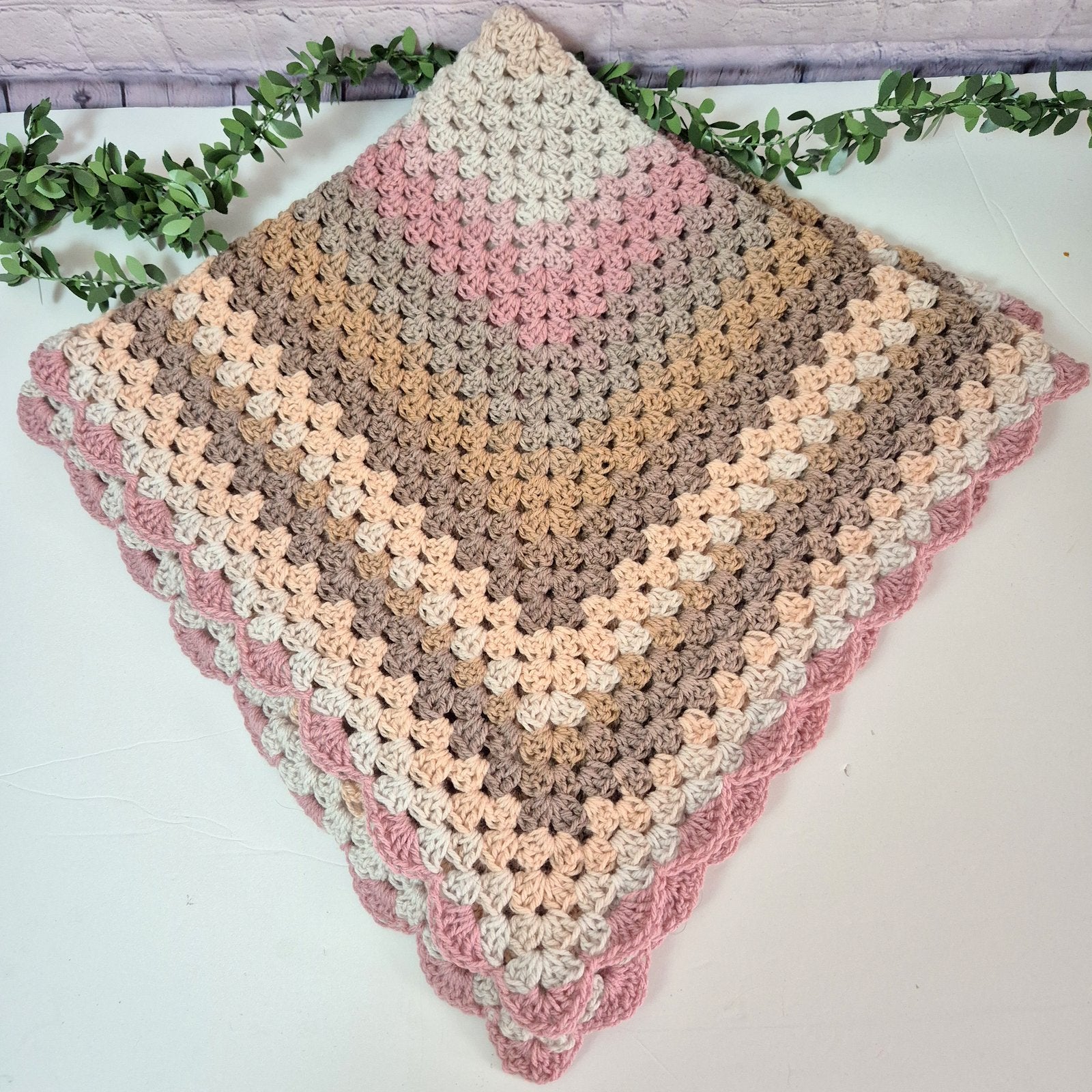 crochet pink cream and brown baby blanket 
