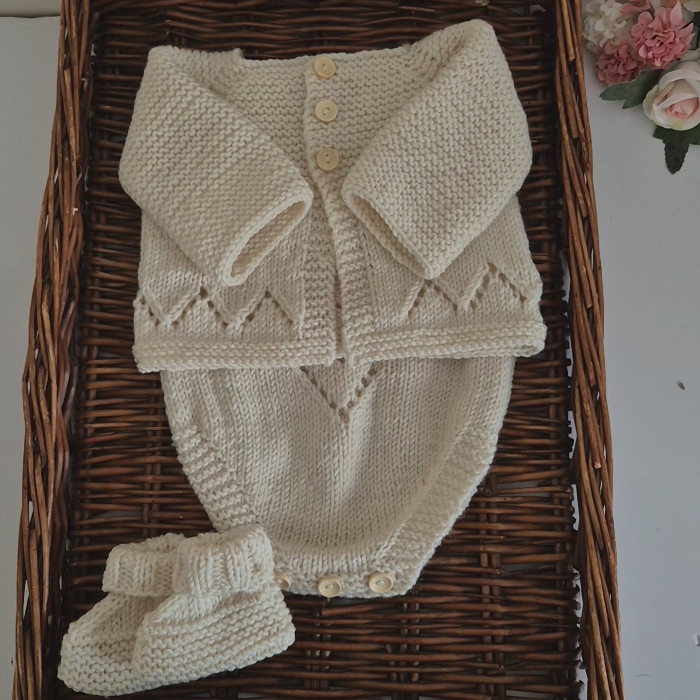 Handknit baby cardigan, romper and booties set. Ready to send. The outfit is made to fit a baby of 0-3 months old. Perfect as a baby shower gift or as a gorgeous set to match your baby's wardrobe.

The cardigan is knit with a chevron lace pattern on the edge, and a ridged pattern across the bodice and sleeves, with wooden buttons down the front. The matching romper has shoulder straps, the same chevron lace pattern, and buttons for diaper changes.