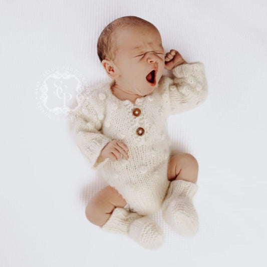 handmade knitted baby romper with long sleeves and popcorn pattern and matching booties