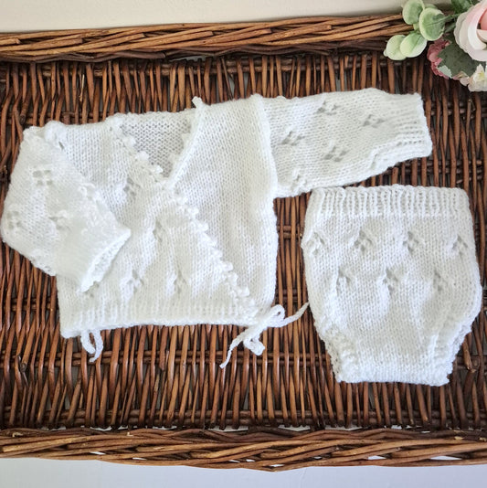 Hand knit baby girl cardigan outfit. Newborn cross over kimono style cardigan with a lace Pattern, scalloped edge, and long sleeves. The fronts have bow-ties at the edge.

Made in sizes Preemie / Newborn / 0-3 months
A pair of matching pants with the same pattern completes the outfit. Knit in soft acrylic yarn that is easy to wash.
This is perfect as a hospital coming home outfit, newborn photography prop or as a baby shower gift for a baby girl. All my knitwear is shipped in an organza bag, ready for you t