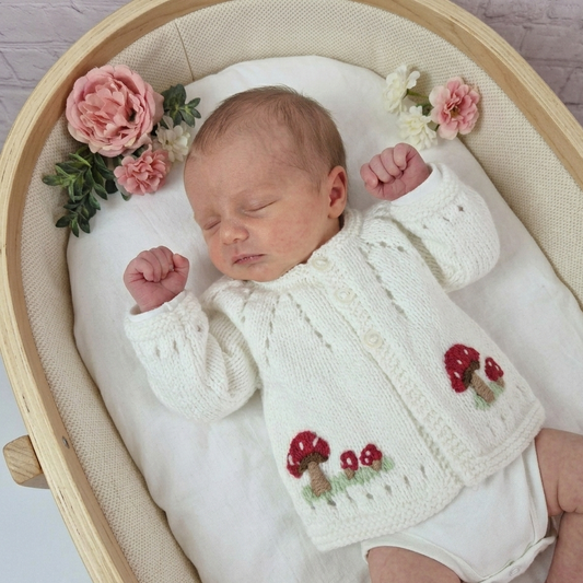 Hand Knit Baby Cardigan with embroidered red Toadstools.
Newborn or 0-3 months Sweater.
This little jumper has a button front with little red toadstools embroidered on the hemline