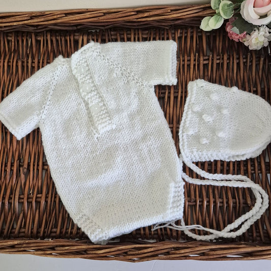 Handknit newborn romper and bonnet set, made in soft acrylic yarn with an all-over popcorn bubble pattern. The romper has a round neckline with buttons at the back, short sleeves, diaper buttons for easy changes. Gender neutral style that is perfect as a hospital coming home outfits, newborn photography sessions, or baby shower gifts.&nbsp;