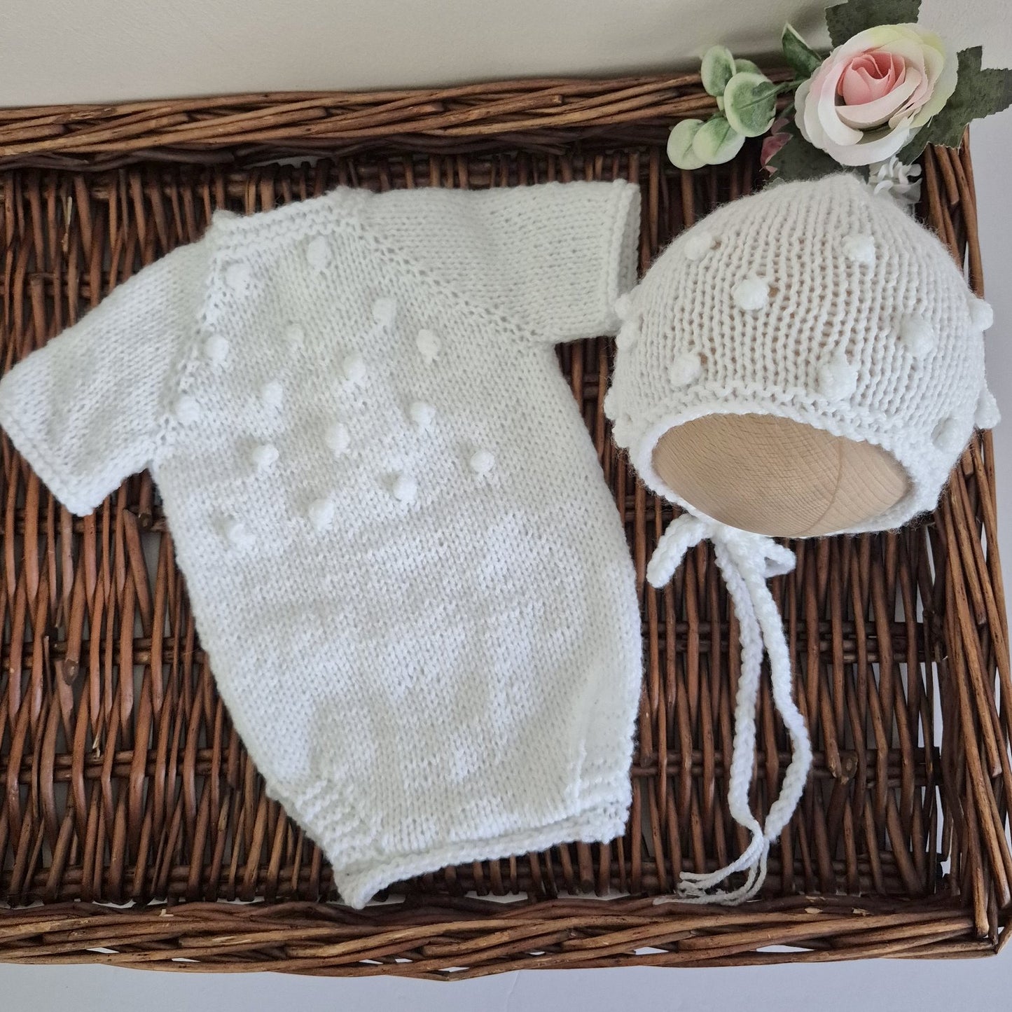 Handknit newborn romper and bonnet set, made in soft acrylic yarn with an all-over popcorn bubble pattern. The romper has a round neckline with buttons at the back, short sleeves, diaper buttons for easy changes. Gender neutral style that is perfect as a hospital coming home outfits, newborn photography sessions, or baby shower gifts.&nbsp;