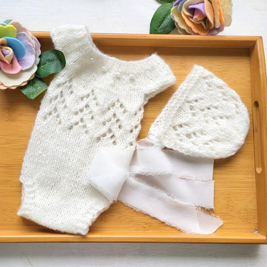 white knit newborn baby girl romper with lace and pearls, with a matching headband with frayed ribbon ties