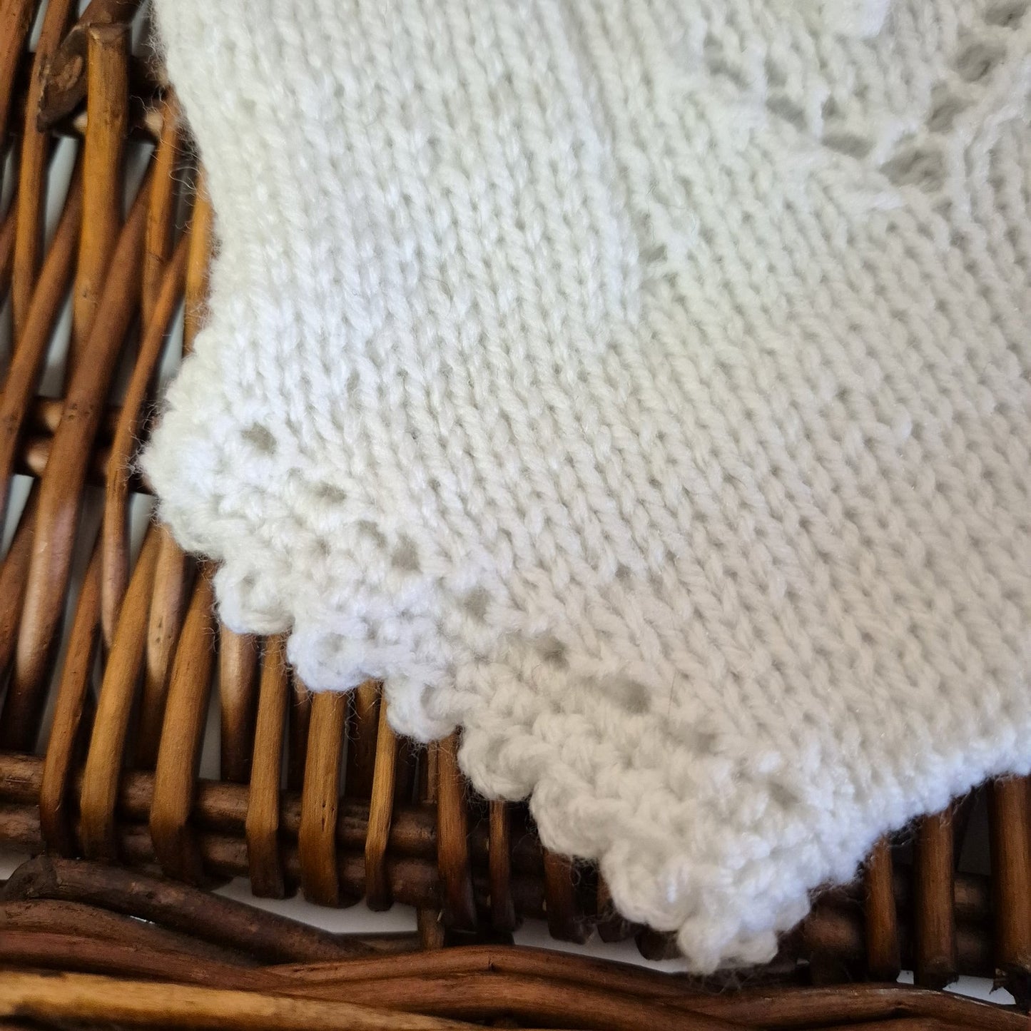 A sweet handknit lace and popcorn romper for a baby girl from newborn to 3 months old.

The darling little romper has a lace and popcorn pattern panel down the front, with scalloped frill on the legs and shoulder straps.