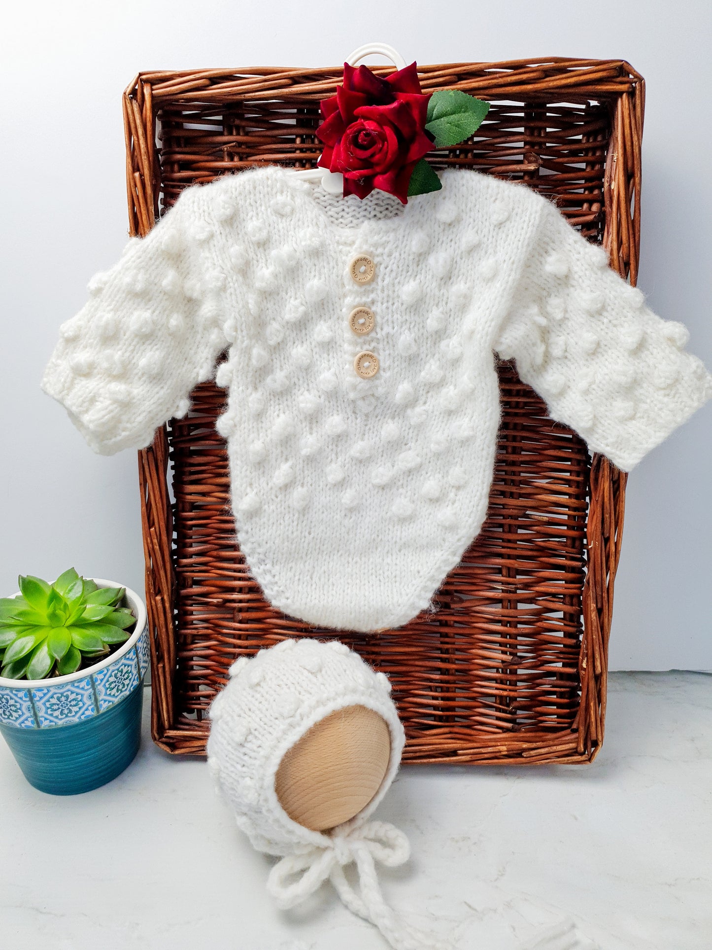 handknit cream baby romper with bobble pattern and long sleeves, legless romper with matching bonnet