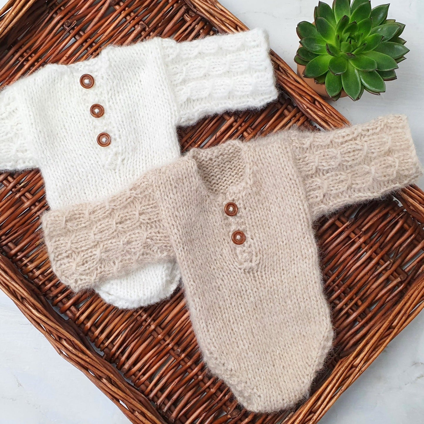 handknit newborn baby romper with cable or lace sleeves