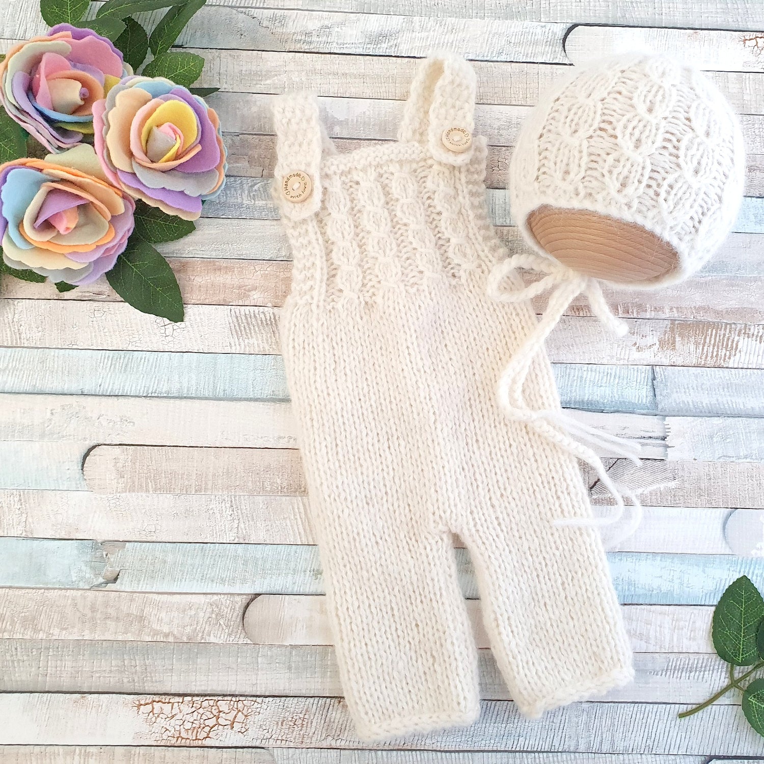 knitted baby dungaree and bonnet in cream 